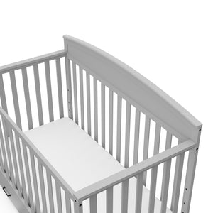 Close-up view of Pebble gray crib with drawer
