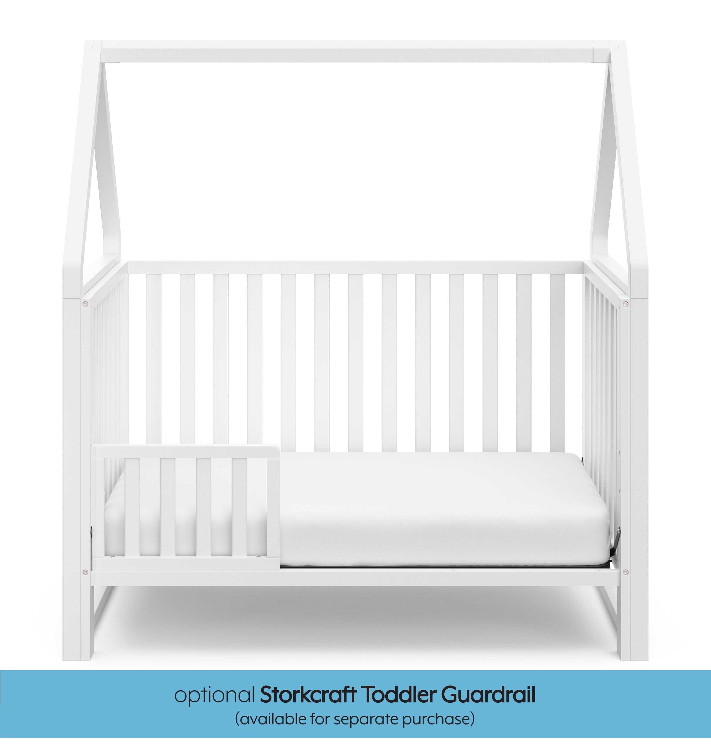 White crib in toddler bed conversion with one safety guardrail graphic