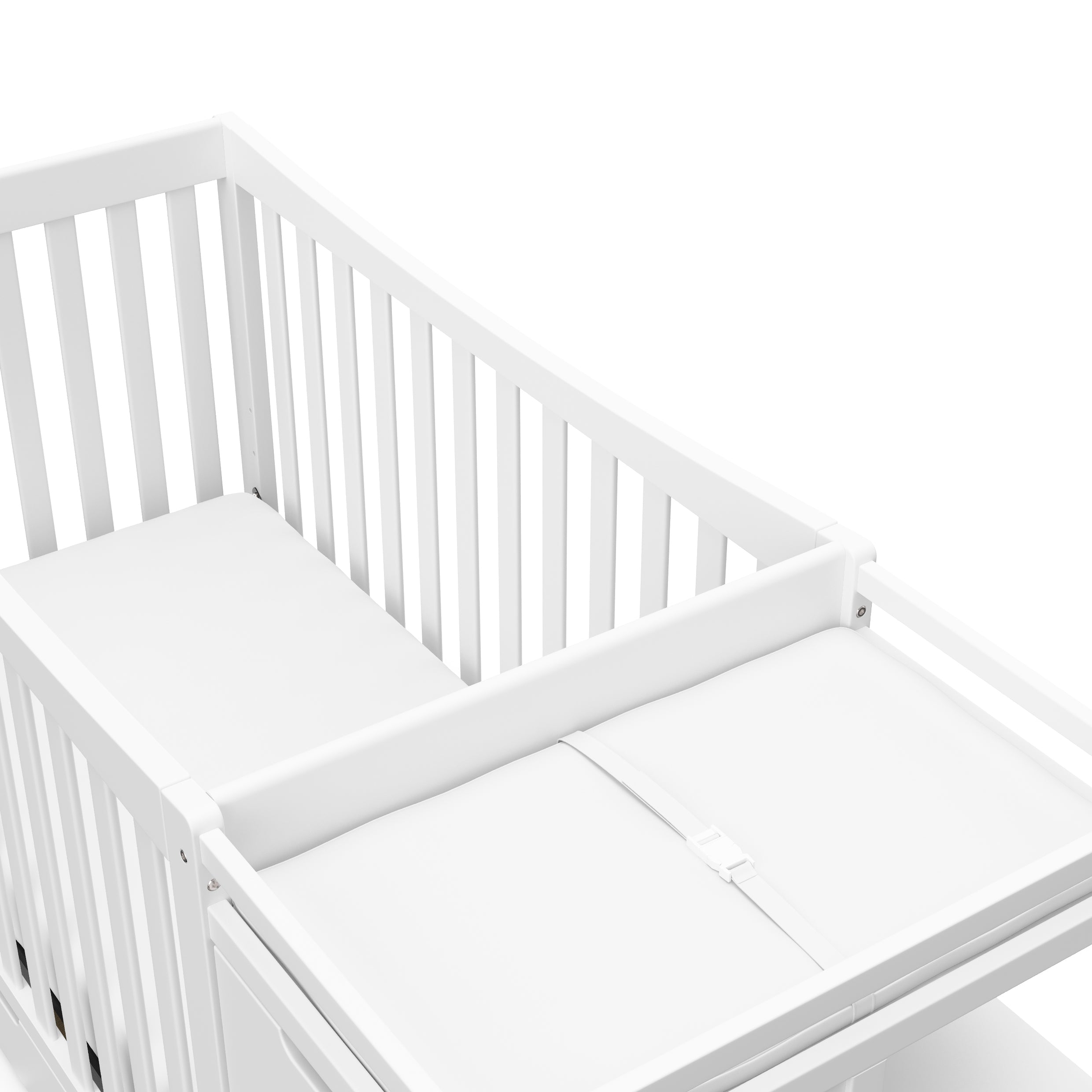 Close-up view of White crib and changer