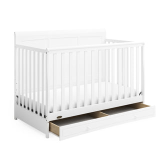 White crib with open drawer angled