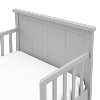 Close-up view of pebble gray toddler bed’s headboard