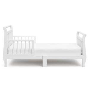 Side view of white toddler bed with guardrails