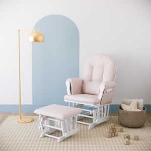 white glider and ottoman with pink cushions in nursery