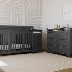 gray crib and changer in nursery with 6 drawer dresser 