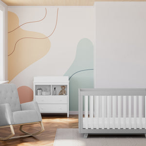 Natural with steel glider in nursery with a crib and a changing chest