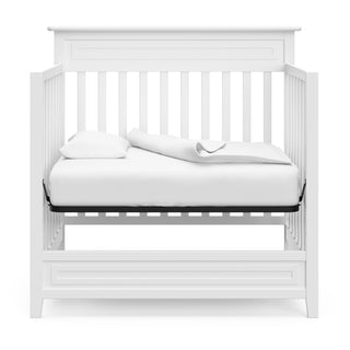 White mini crib in daybed conversion 