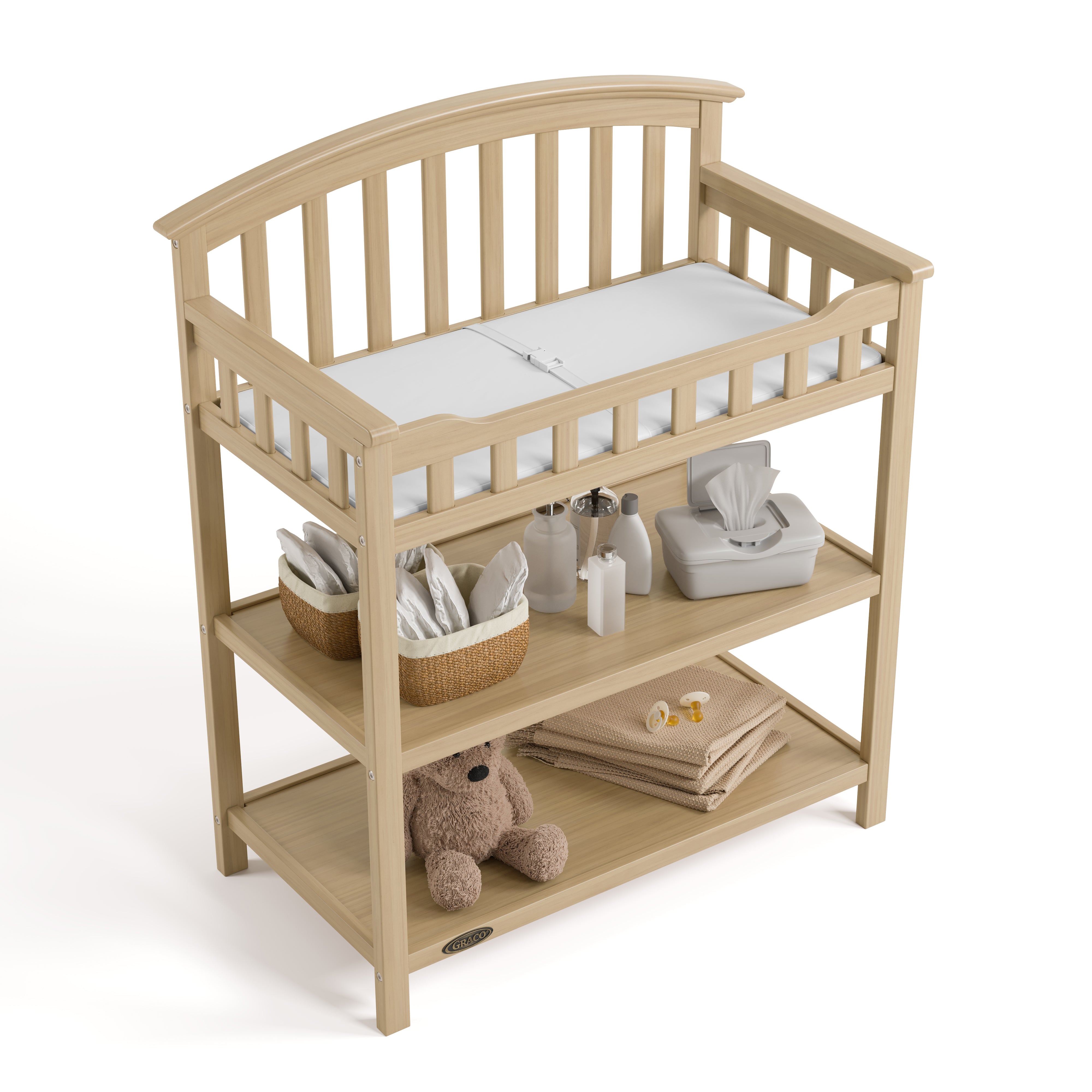 Graco driftwood changing table top view with baby items on shelves