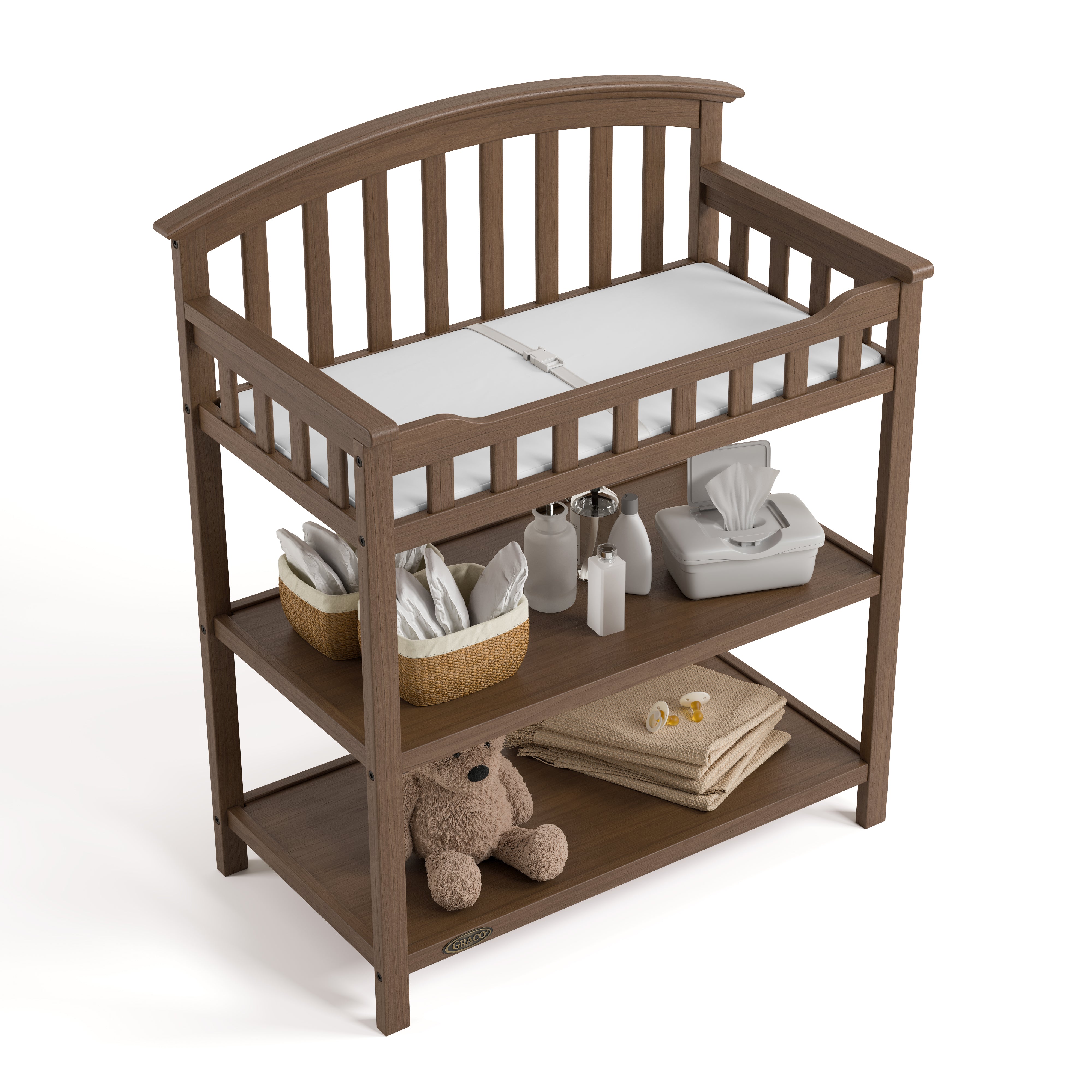 Graco hazelnut changing table top view with baby items on shelves