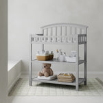 Graco pebble gray changing table in a nursery