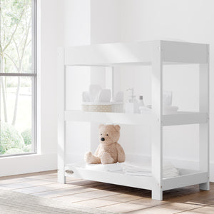 White changing table with removable headboard in nursery