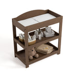 Customizable hazelnut changing table with baby items on both shelves top view