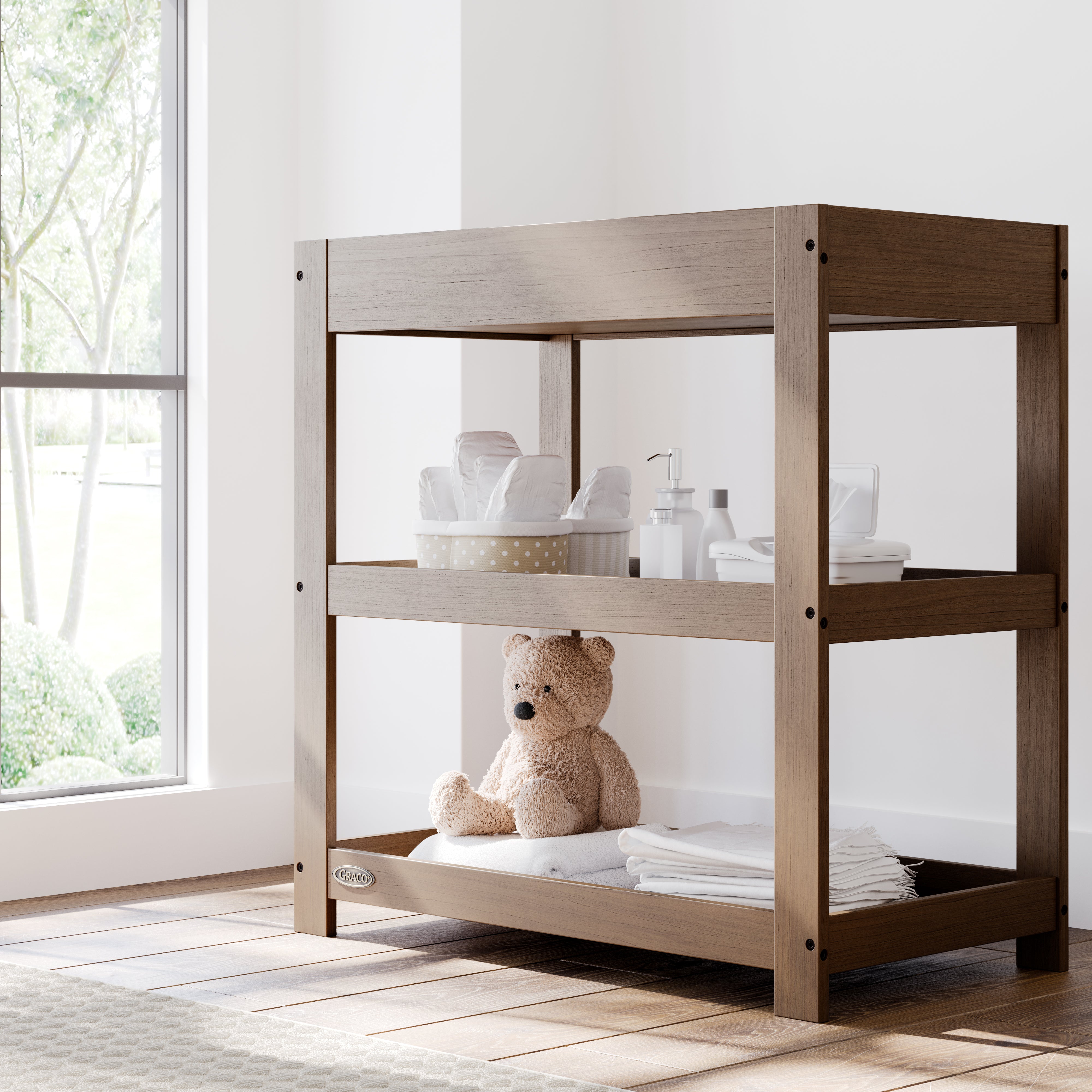 Graco hazelnut customizable changing table in nursery