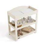 Customizable frosted oat changing table with baby items on both shelves top view