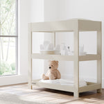 Customizable frosted oat changing table in nursery