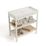 Morningside frosted oat changing table top view with baby items on both shelves