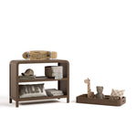 Santos hazelnut changing table with changing topper removed to the right and kids essentials on top