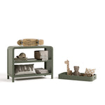 Santos olive changing table with changing topper removed to the right and kids essentials on top