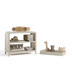 Santos frosted oat changing table with changing topper removed and baby items on both shelves