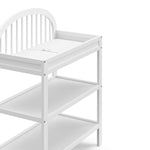 Olivia white changing table close up of changing topper, shelves, and headboard