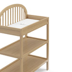 Olivia driftwood changing table close up of changing topper, shelves, and headboard