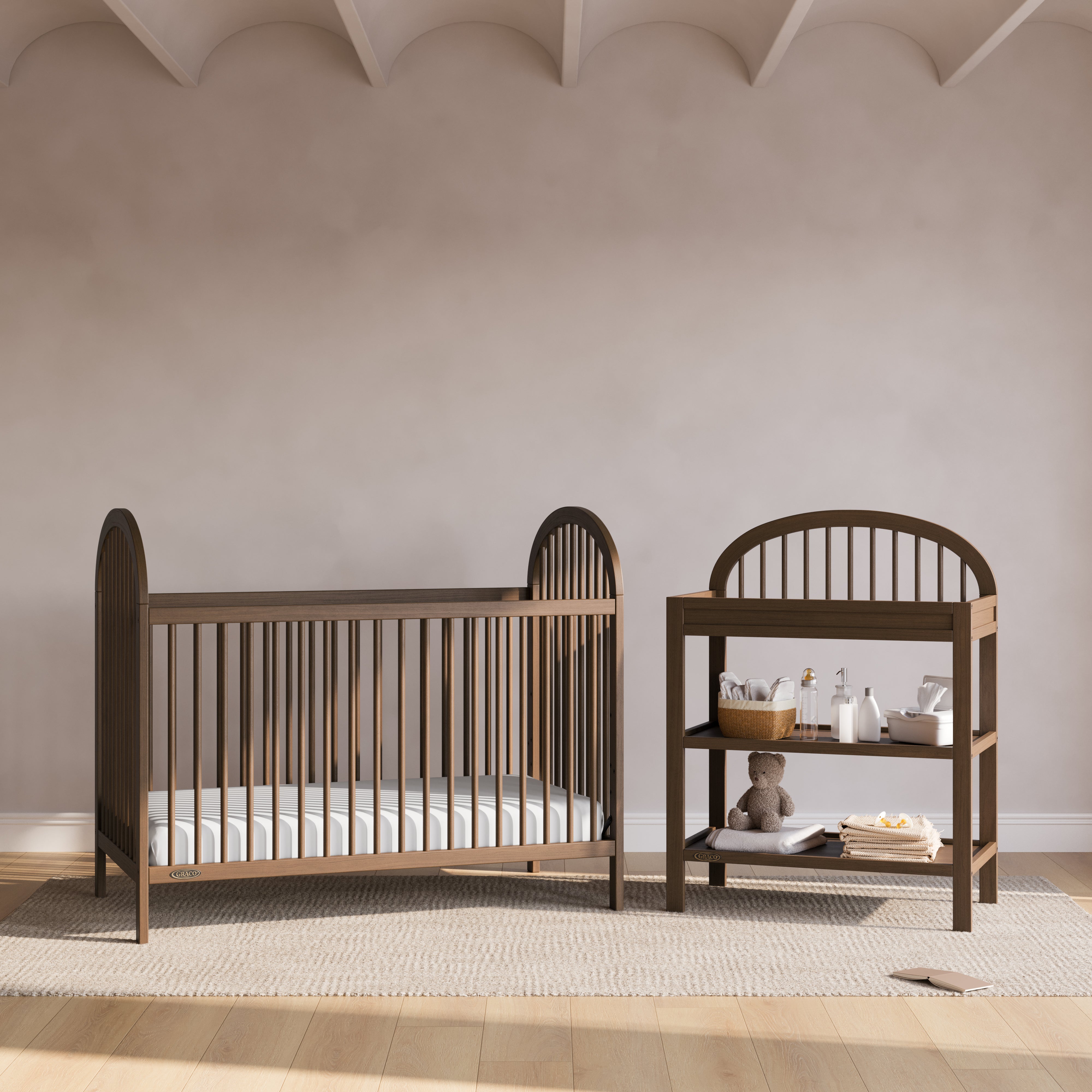 Olivia hazelnut changing table next to crib in a nursery