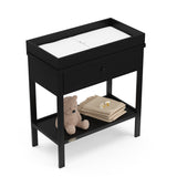 Black Graco storage changing table top view with changing pad and baby items on shelf