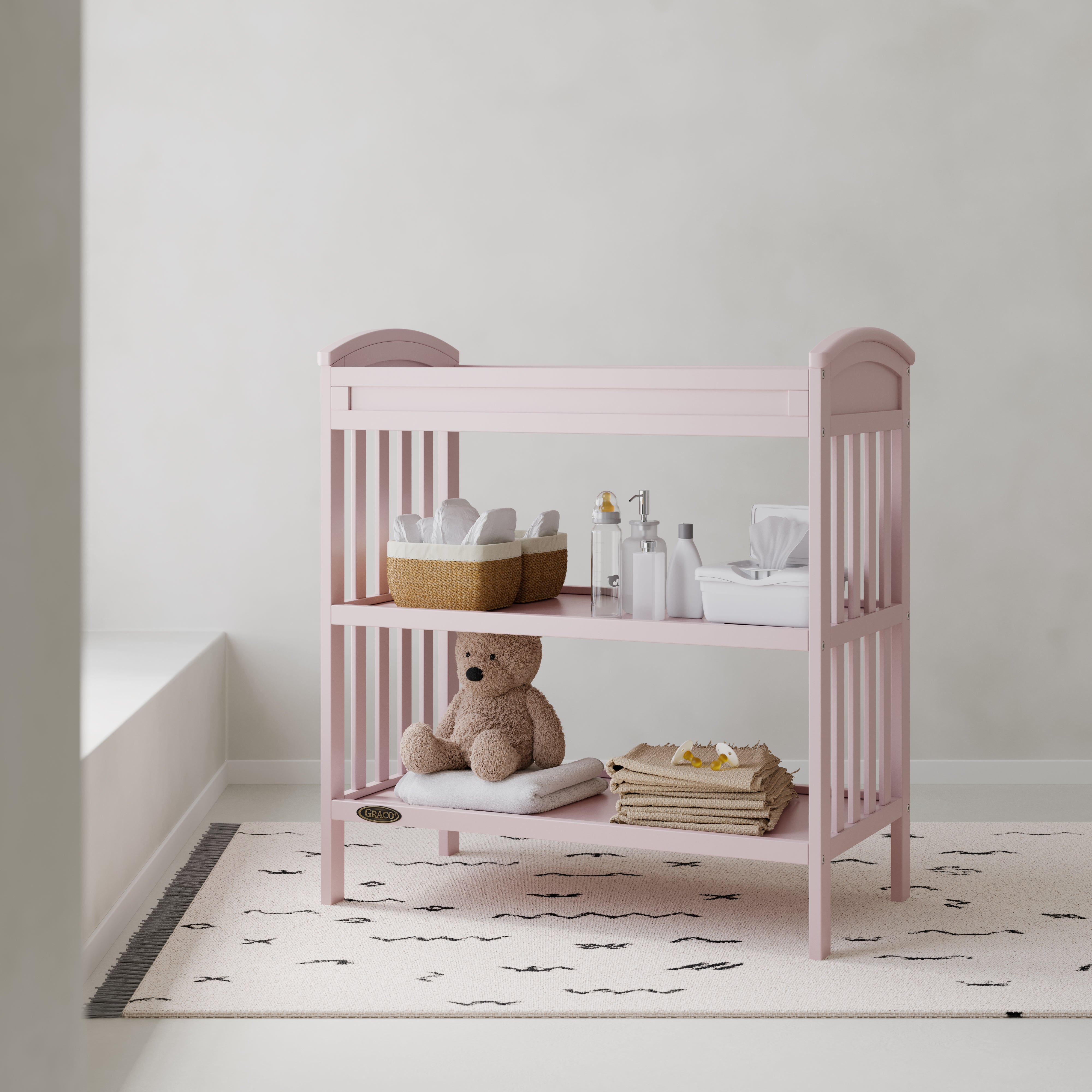 Benton blush changing table in a nursery