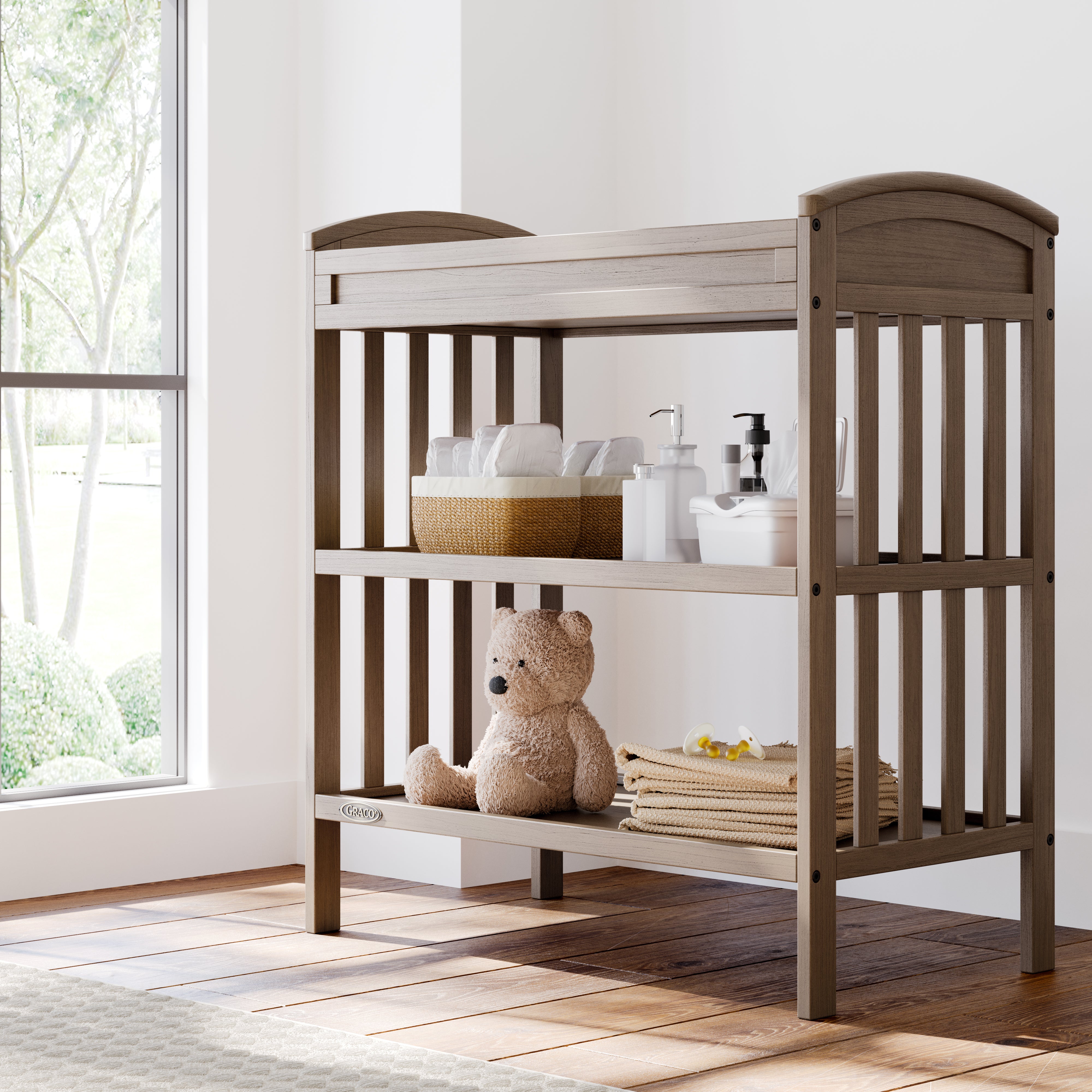 Benton hazelnut changing table in a nursery