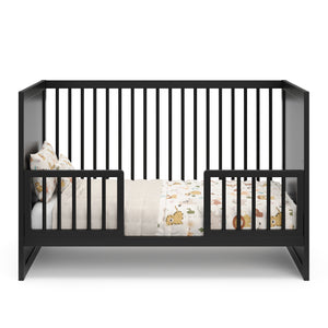 Black Toddler Safety Guardrail Kit with dowels applied in toddler bed