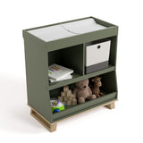 storkcraft modern convertible changing table olive with driftwood top view with changing pad and baby items inside storage cubbies
