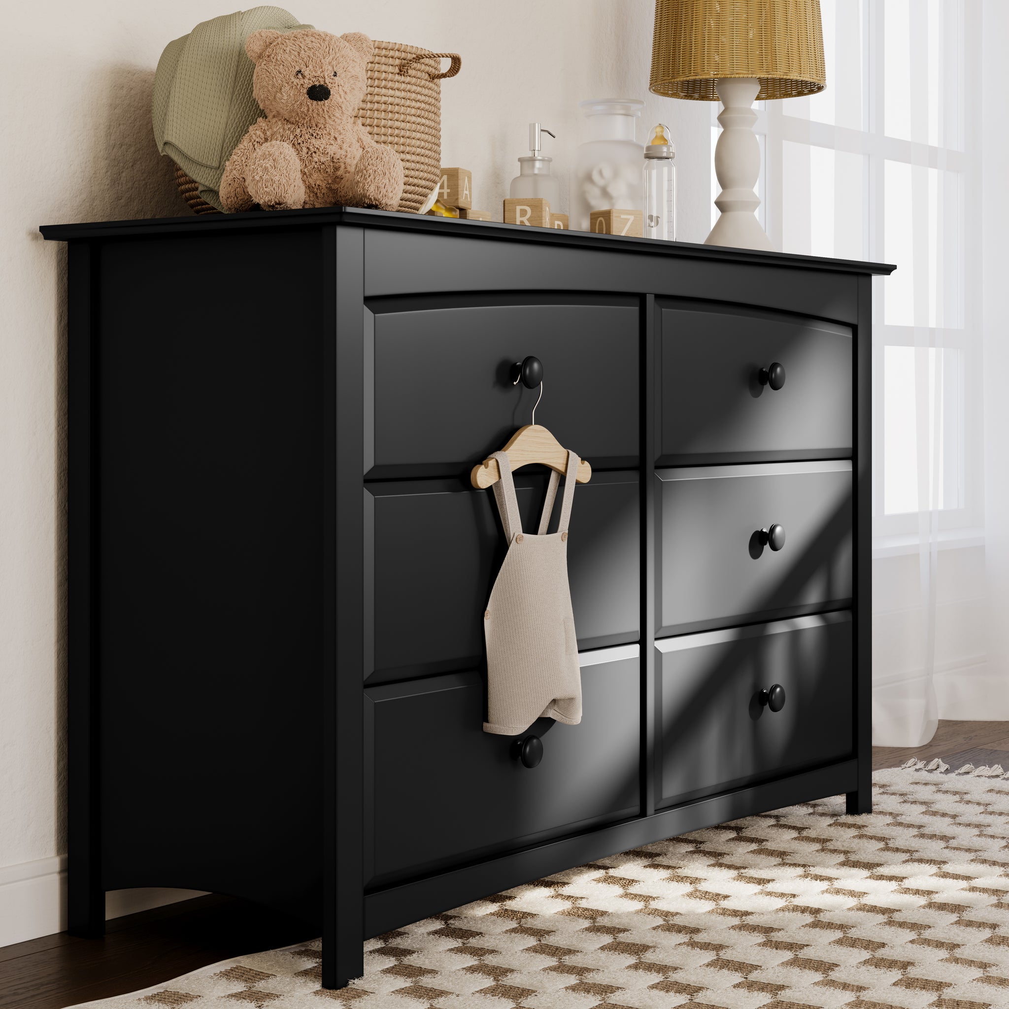 angled black 6 drawer dresser in nursery 