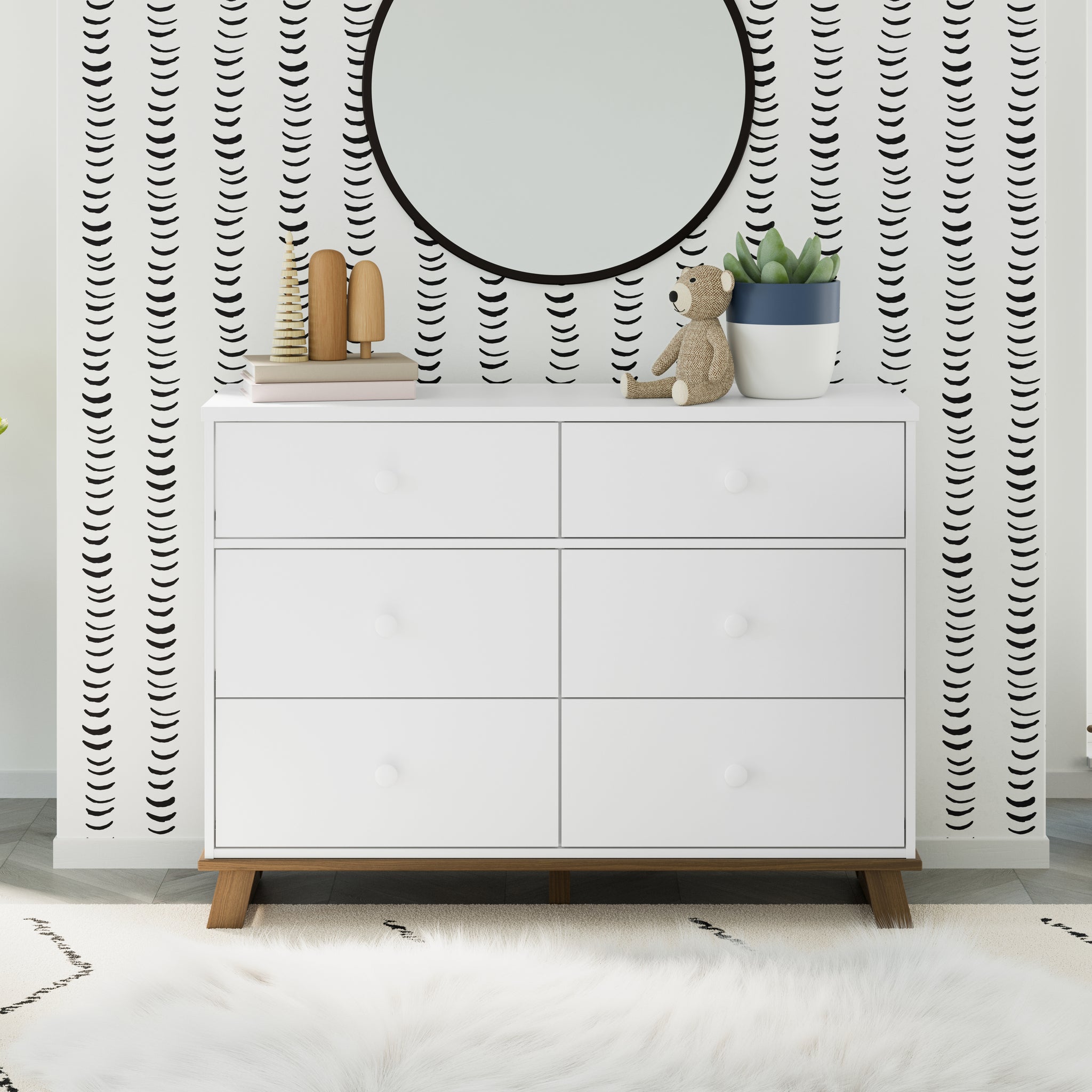 A serene nursery featuring a white and vintage driftwood 6-drawer dresser