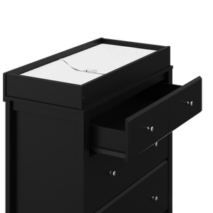close view of angled black 3 drawer chest with changing topper, and one open drawer