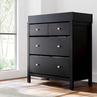 black 3 drawer chest with changing topper in nursery