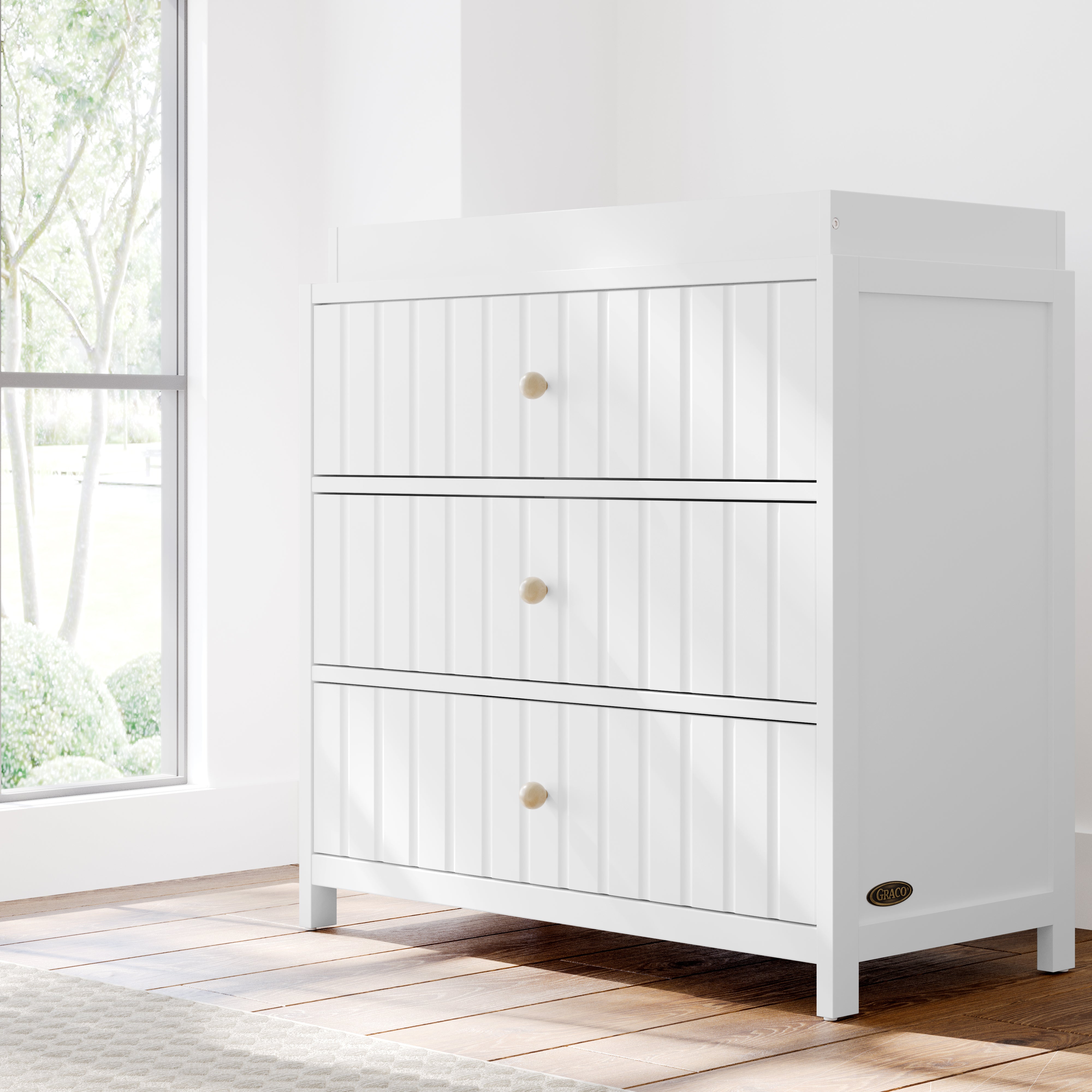 Teddi white with driftwood knobs 3 drawer chest with changing topper in a nursery