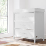 classic white 3 drawer chest with changing topper in nursery by window