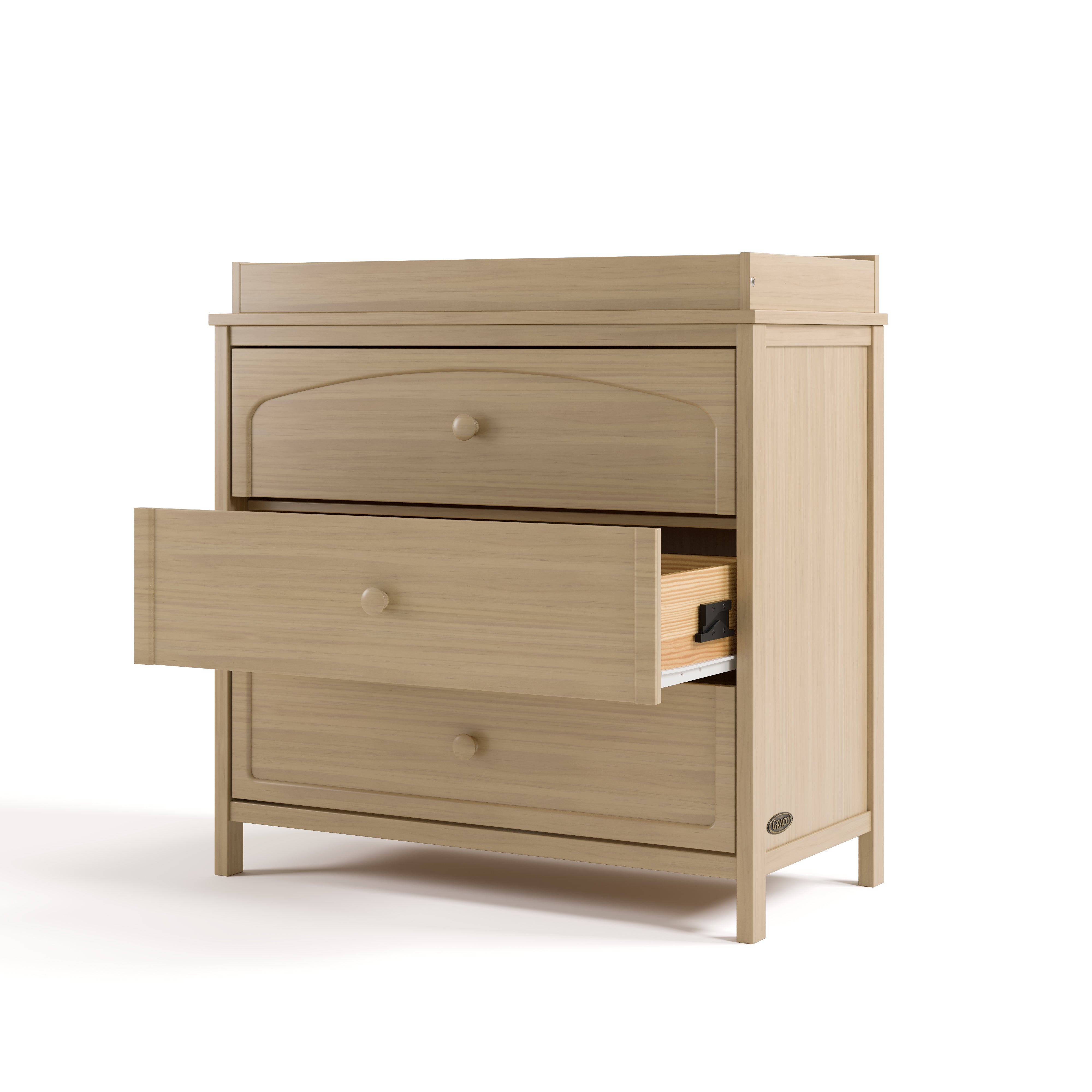 Olivia driftwood 3 drawer chest with changing topper with middle drawer open angle view