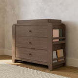 Read-with-Me hazelnut 3 drawer chest with changing topper in a nursery