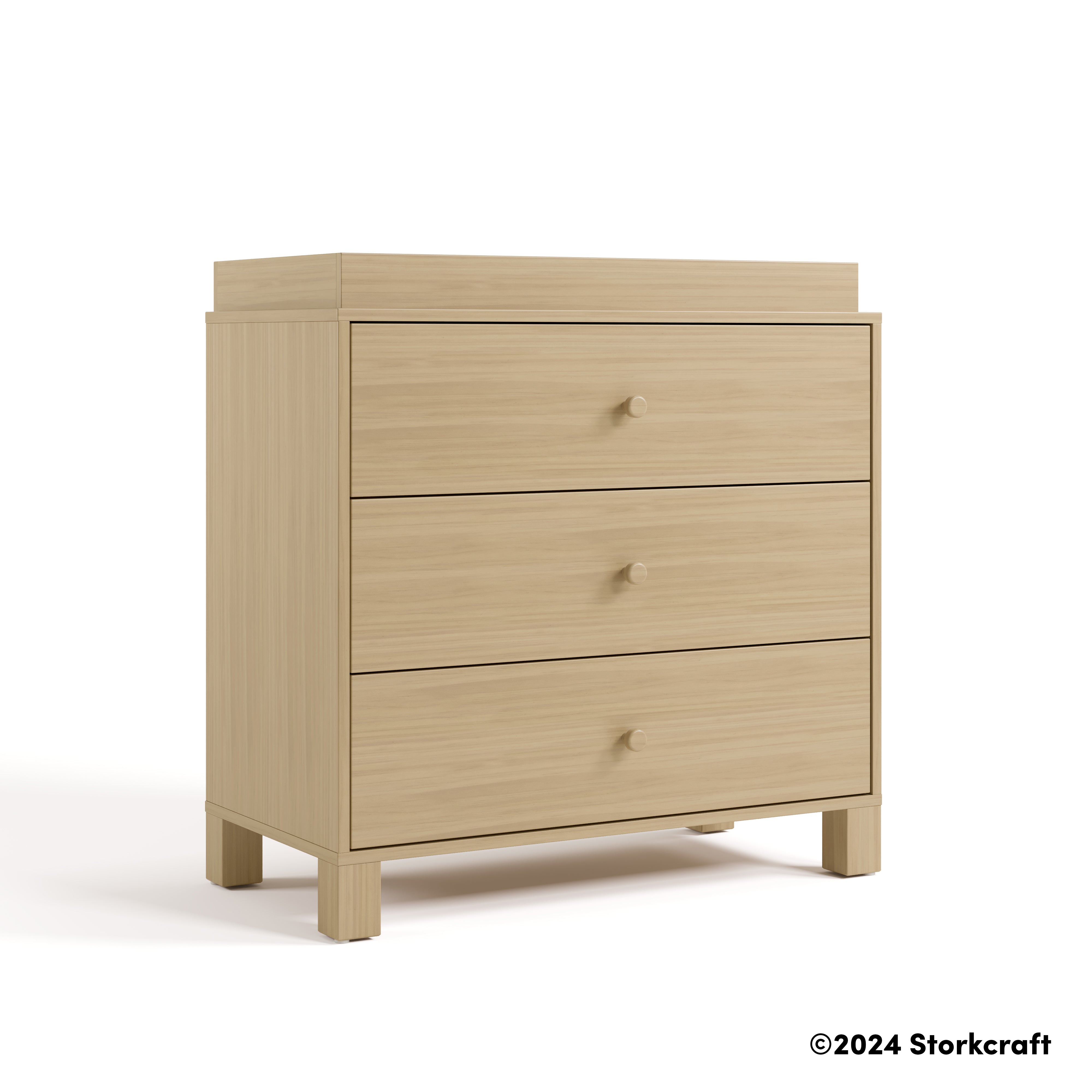 California driftwood 3 drawer chest with topper angle view with Storkcraft 2024 copyright on bottom right