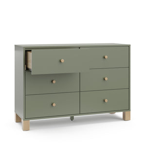 Angled view of olive dresser with driftwood knobs and one open drawer