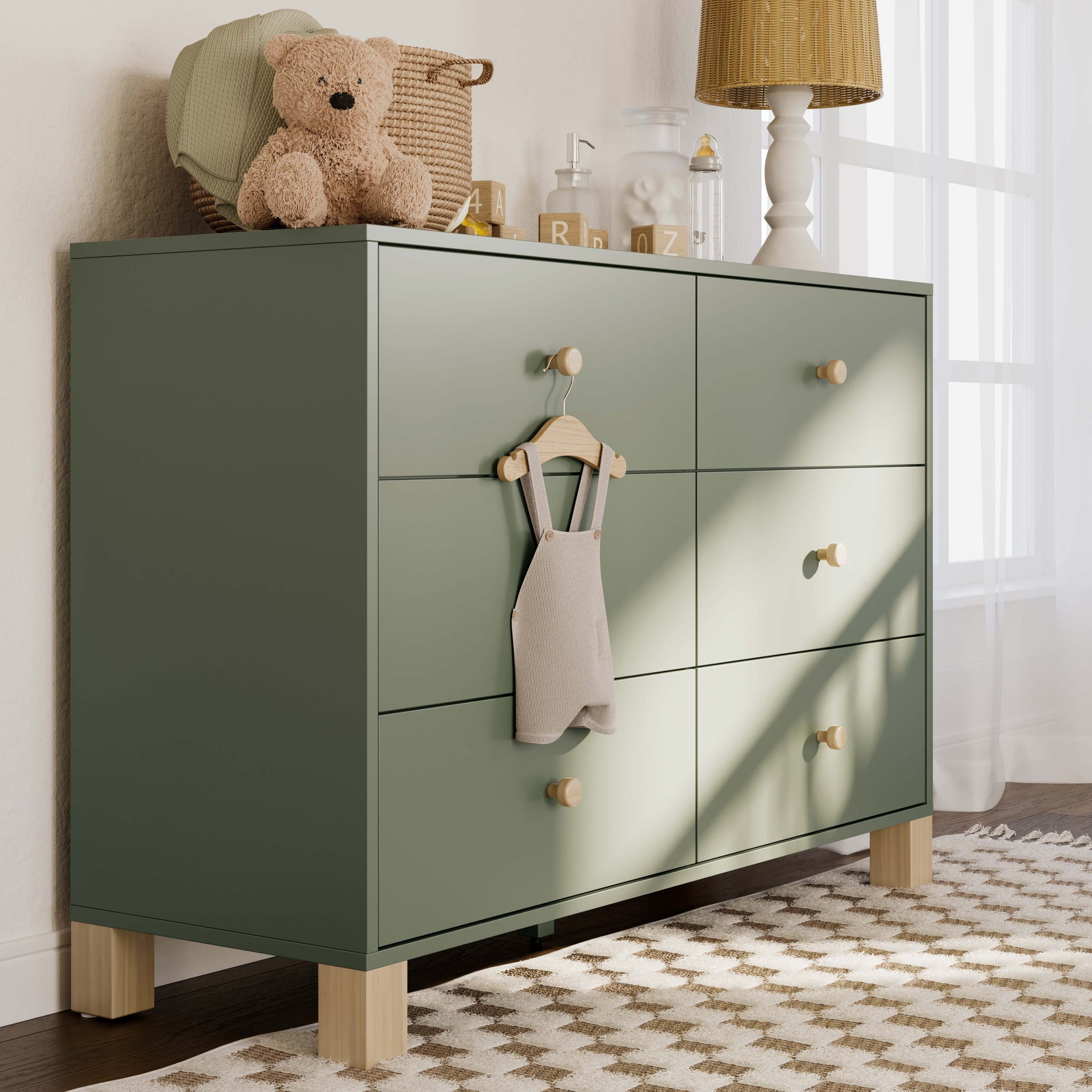 Olive dresser with driftwood knobs in a nursery
