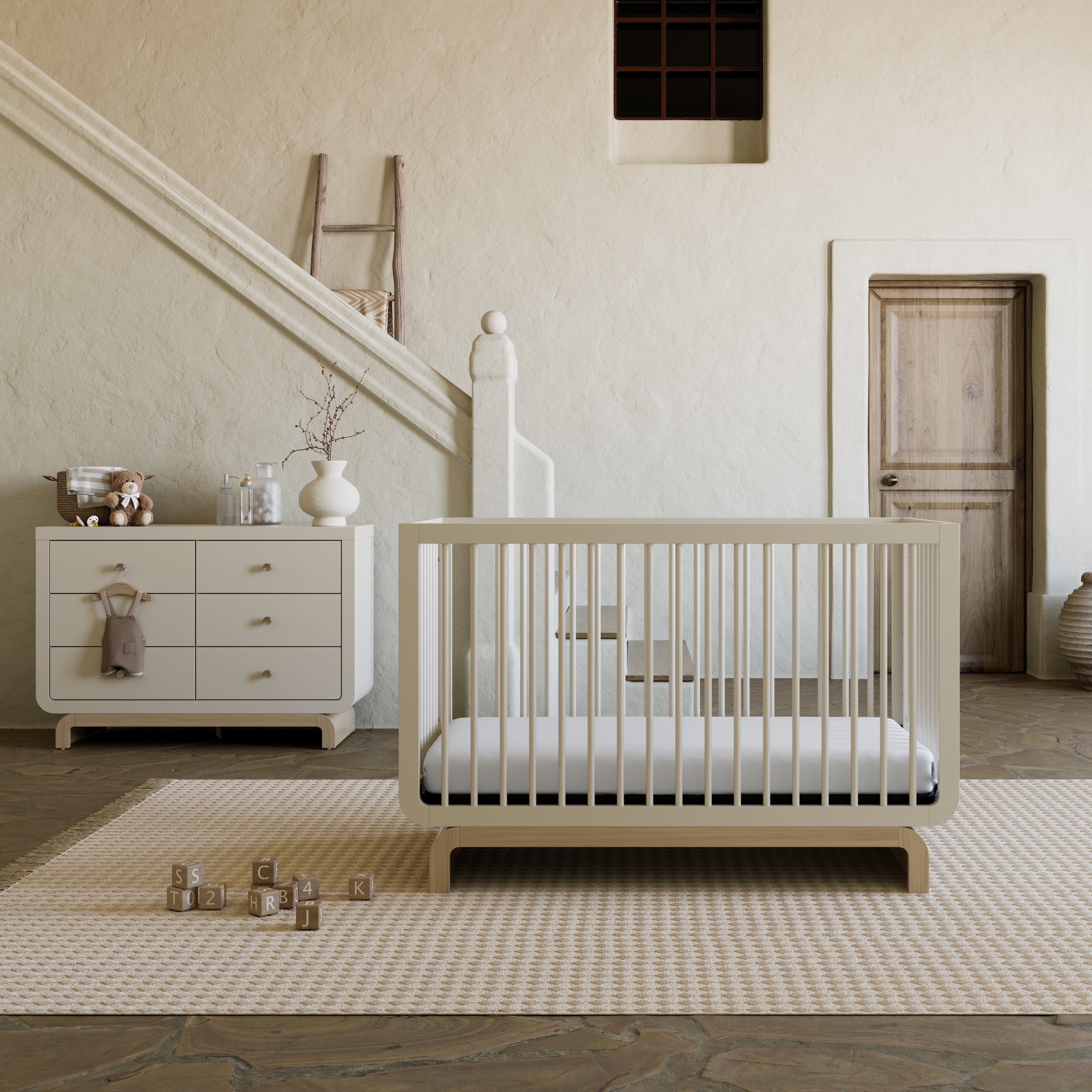 Santorini frosted oat with driftwood 6 drawer dresser in nursery next to Santorini crib