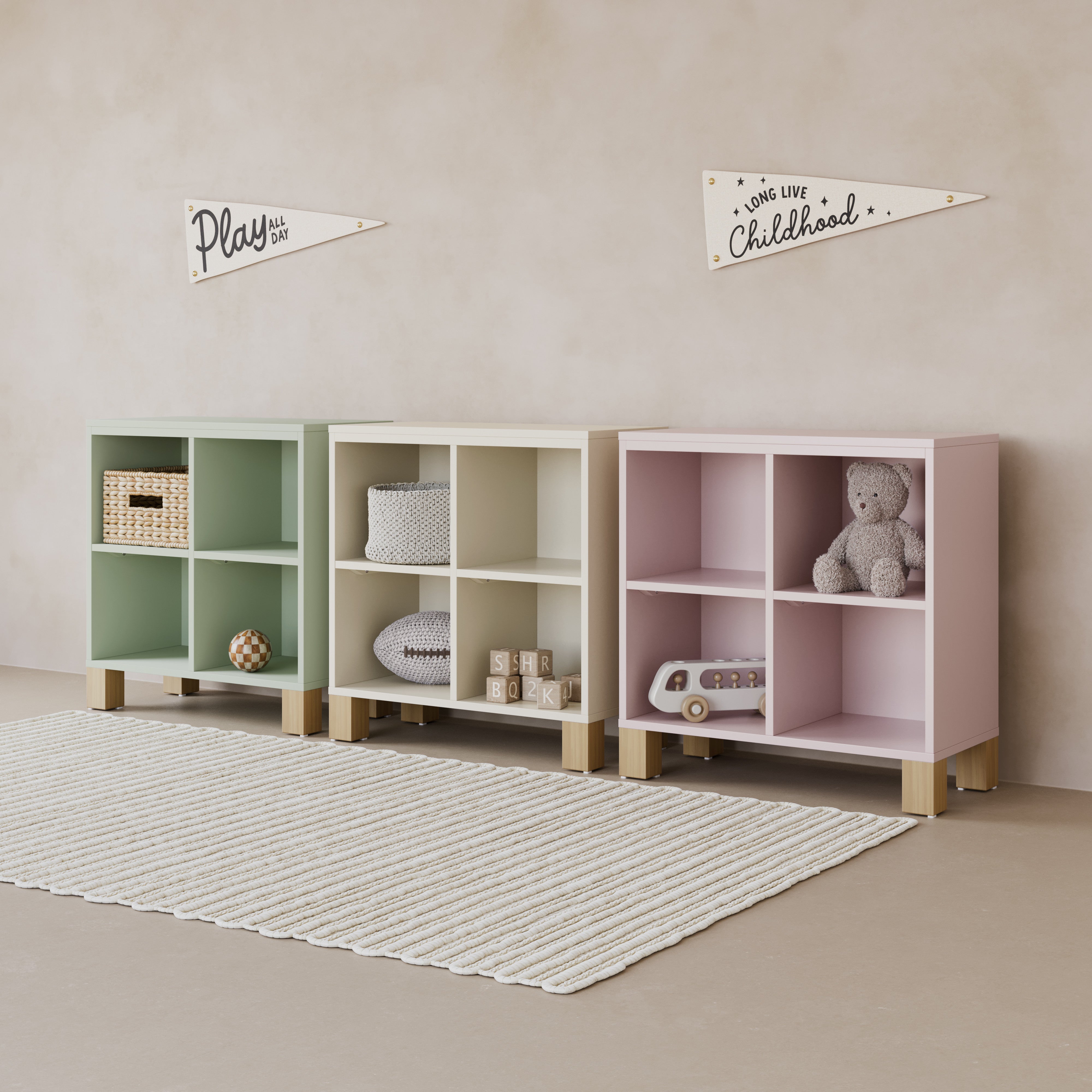 Three bookcases in pastel colors with various decorative children's bedroom items