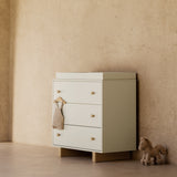 Texas frosted oat with driftwood 3 drawer chest with topper in a nursery