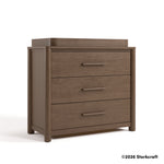 Malta hazelnut 3 drawer chest with changing topper angle view and 2026 Storkcraft copyright on bottom right
