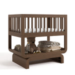 Santorini hazelnut bassinet angle view with baby items on bottom