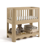 Casablanca driftwood bassinet angle view with baby items on bottom shelf