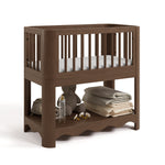 Casablanca hazelnut bassinet angle view with baby items on bottom shelf