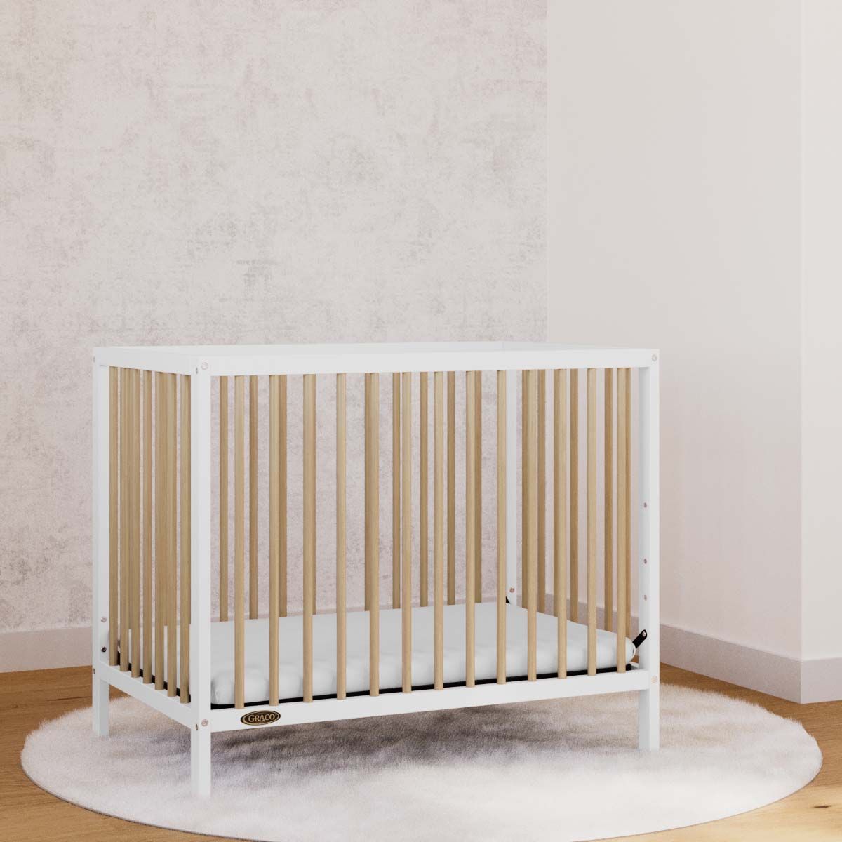 White with driftwood mini crib in nursery
