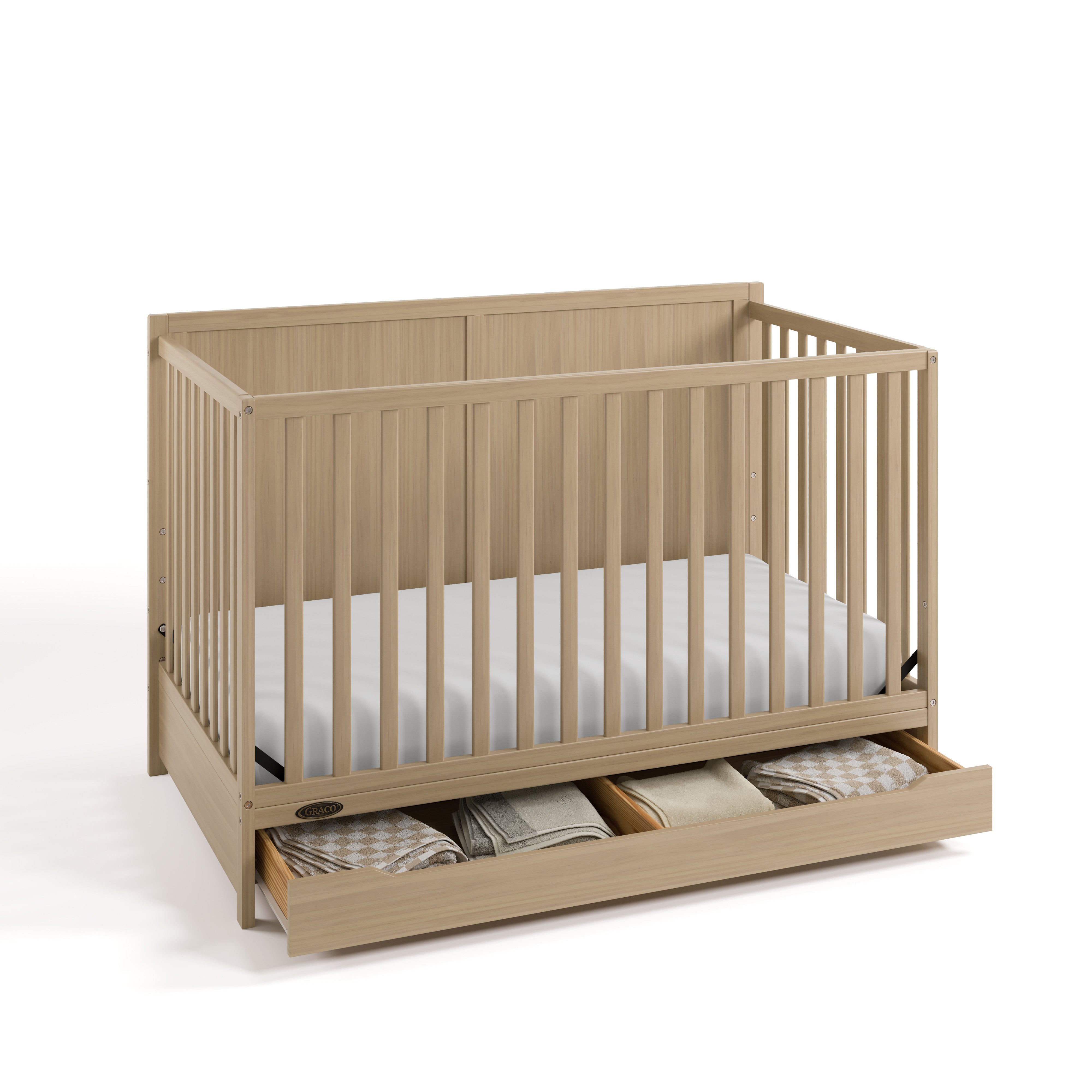 Melrose driftwood crib with drawer open and blankets inside